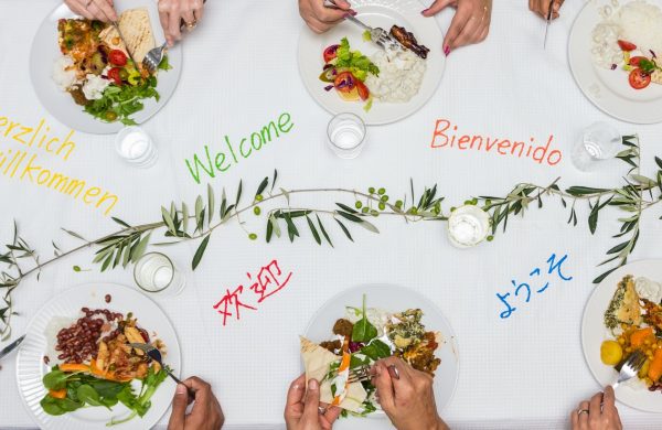 A group of people sitting at a table with plates of food